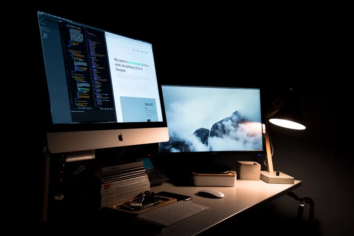 A designer’s workstation with a code editor and portfolio open.