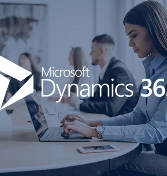 The Microsoft Dynamics 365 logo over a photograph of a team working at laptops.